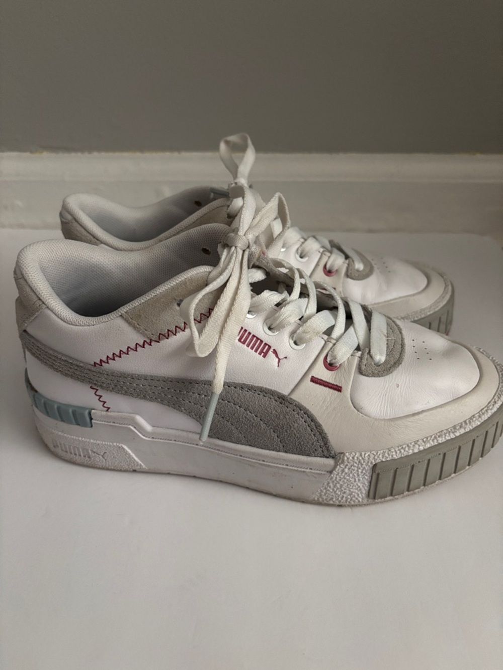 Puma White Sneakers with Light Gray Suede Accents and Red Stitching
